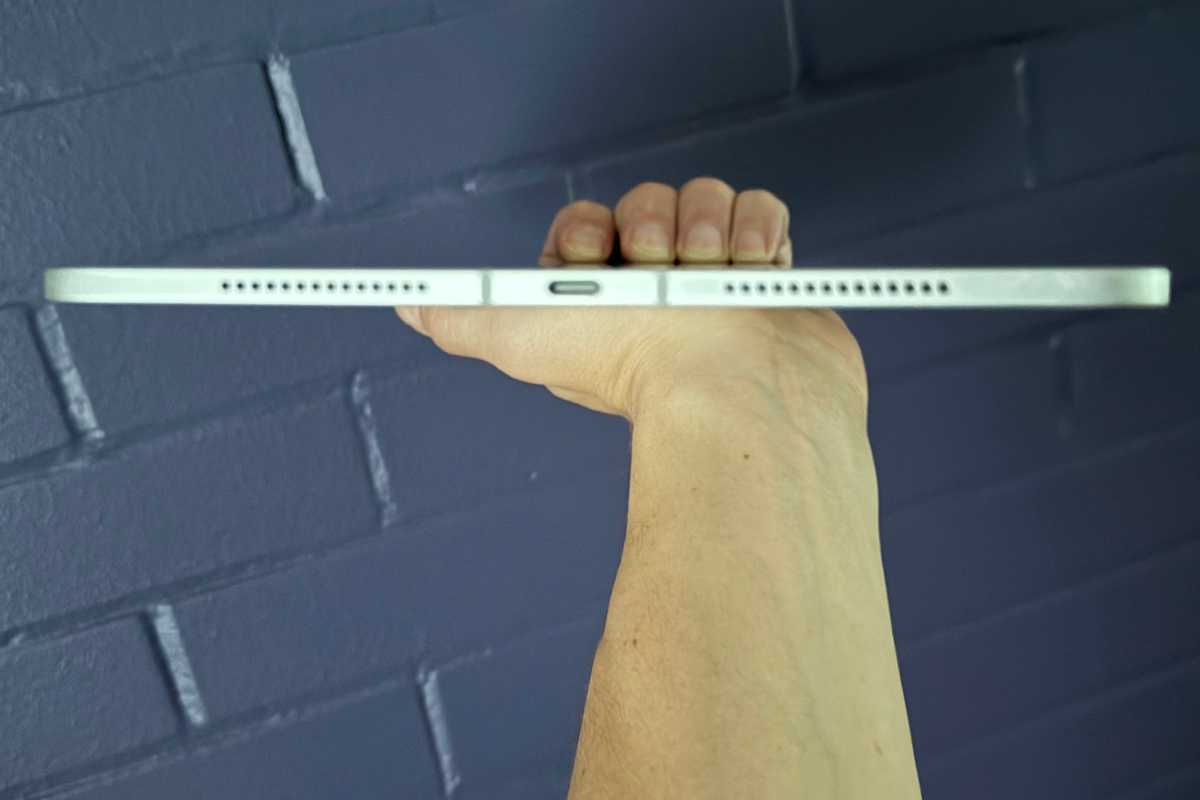 The M4 iPad Pro held at arm's length to show its thinness